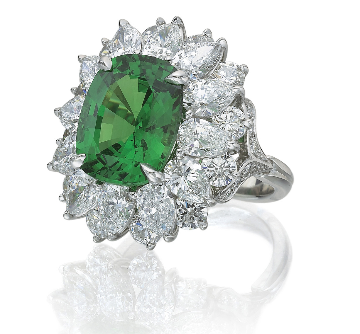 Oval cut emerald and diamond platinum cocktail ring.