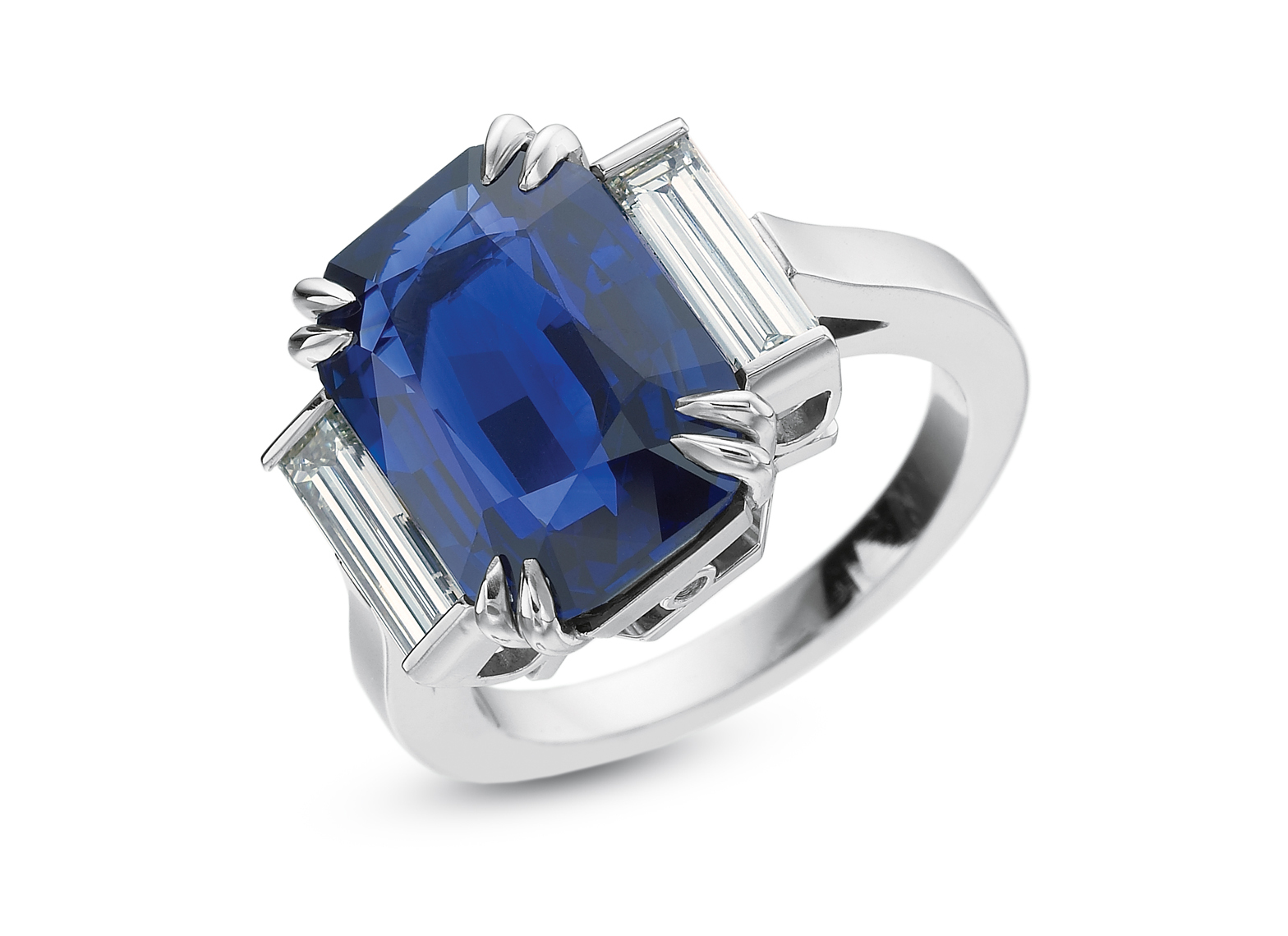 Emerald cut sapphire with baguette diamond side stones platinum ring.